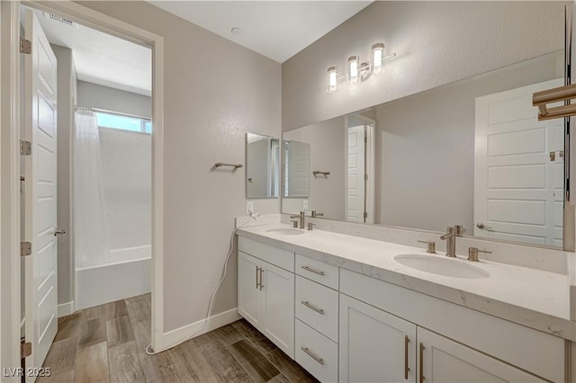 7736 Tioga Ridge Ct, Las Vegas, NV 89117 - full bathroom featuring double vanity, wood finished floors, and shower / tub combination