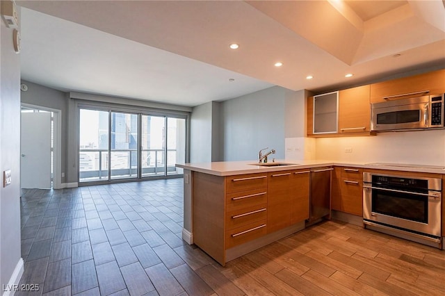 222 Karen Ave Unit 2804, Las Vegas, NV 89109 - kitchen featuring stainless steel appliances, open floor plan, a peninsula, wood finished floors, and recessed lighting