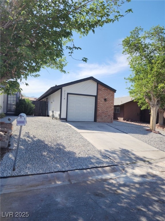 2318 El Molino Cir, Las Vegas, NV 89108 - view of front facade with driveway, a garage, and brick siding