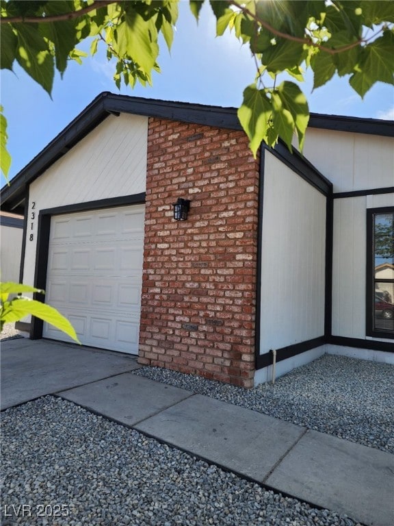2318 El Molino Cir, Las Vegas, NV 89108 - view of property exterior featuring a garage, brick siding, and driveway