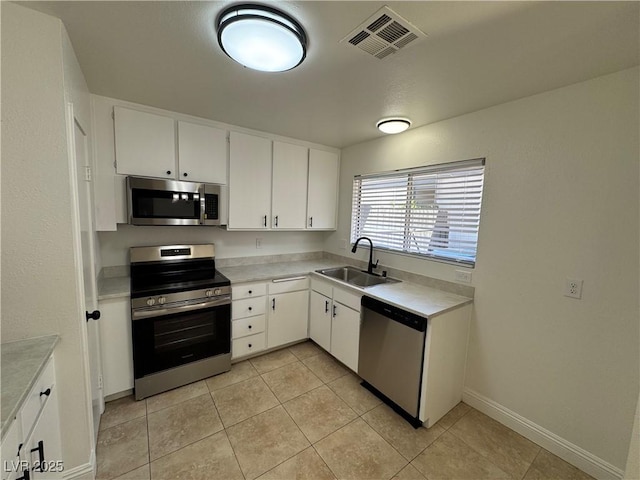 2318 El Molino Cir, Las Vegas, NV 89108 - kitchen featuring stainless steel appliances, light countertops, light tile patterned floors, and white cabinets