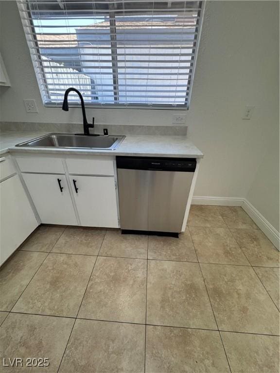 2318 El Molino Cir, Las Vegas, NV 89108 - kitchen featuring dishwasher, white cabinetry, light tile patterned flooring, and light countertops