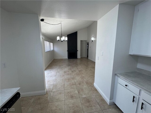2318 El Molino Cir, Las Vegas, NV 89108 - unfurnished dining area featuring a chandelier, light tile patterned floors, lofted ceiling, and a textured ceiling