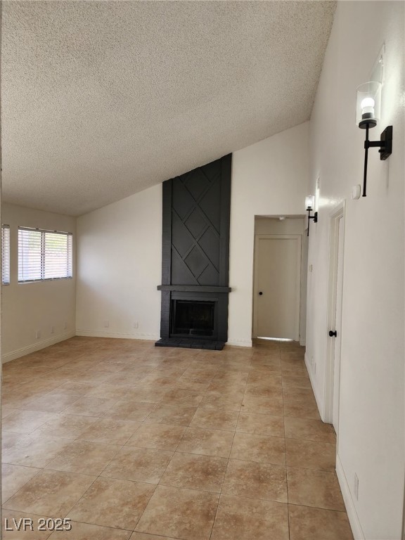 2318 El Molino Cir, Las Vegas, NV 89108 - unfurnished living room featuring a textured ceiling, a fireplace, light tile patterned floors, and lofted ceiling