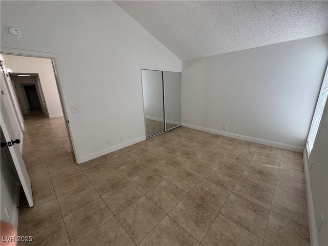 2318 El Molino Cir, Las Vegas, NV 89108 - unfurnished bedroom featuring tile patterned flooring, a textured ceiling, a closet, and high vaulted ceiling