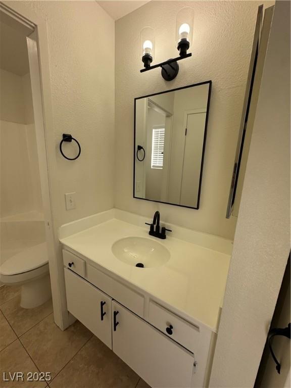 2318 El Molino Cir, Las Vegas, NV 89108 - full bathroom with vanity, tile patterned floors, a textured wall, and a shower