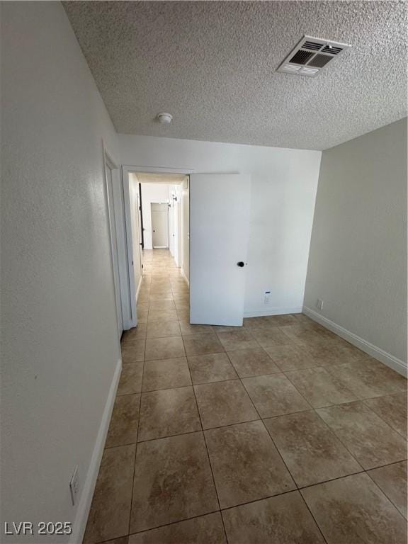 2318 El Molino Cir, Las Vegas, NV 89108 - spare room with tile patterned flooring, a textured ceiling, and a smoke detector