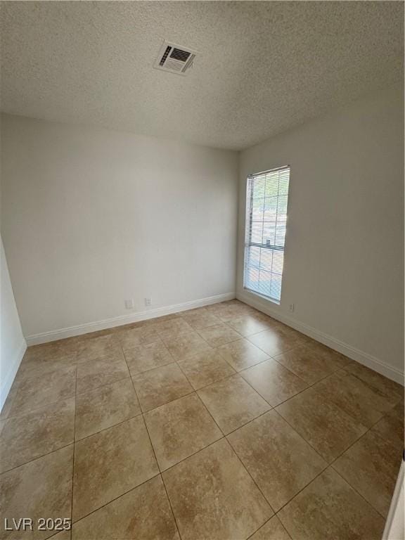 2318 El Molino Cir, Las Vegas, NV 89108 - unfurnished room with a textured ceiling and light tile patterned floors