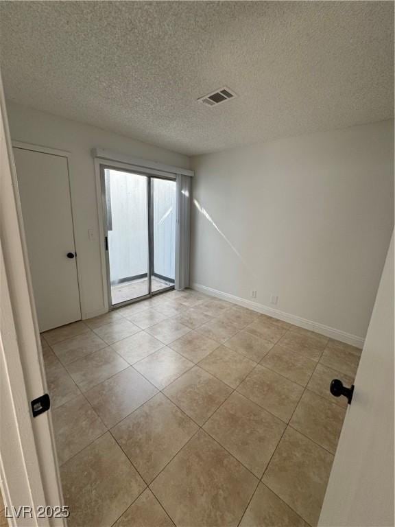 2318 El Molino Cir, Las Vegas, NV 89108 - spare room featuring a textured ceiling and light tile patterned floors
