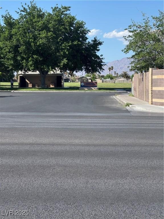 2318 El Molino Cir, Las Vegas, NV 89108 - view of asphalt road with sidewalks, a mountain view, and curbs