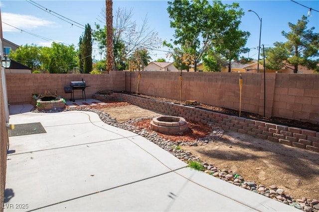 5216 Loma Verde Ave, Las Vegas, NV 89108 - fenced backyard with a fire pit, a patio area, and a grill