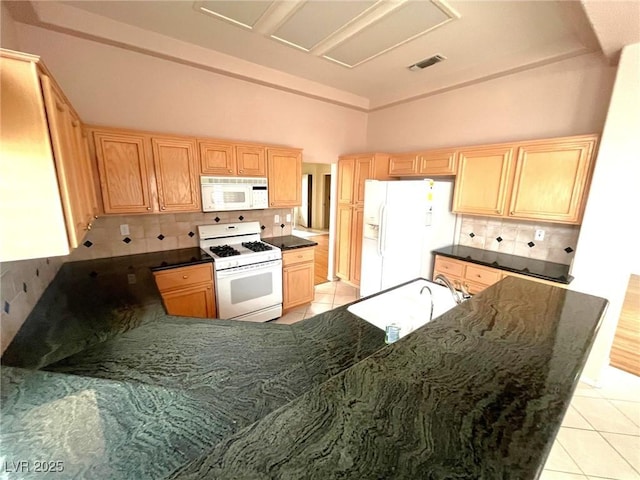 2925 Big Green Ln, Las Vegas, NV 89134 - kitchen with white appliances, light tile patterned flooring, tasteful backsplash, light brown cabinets, and high vaulted ceiling