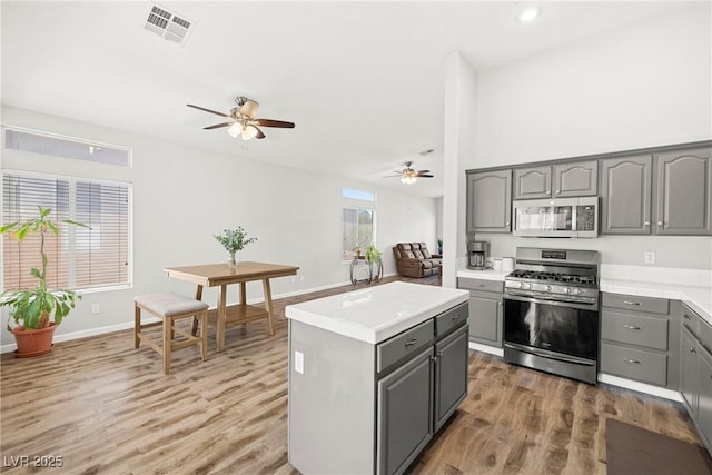 981 Leadville Meadows Dr, Henderson, NV 89052 - kitchen featuring appliances with stainless steel finishes, gray cabinetry, a ceiling fan, light wood-style floors, and recessed lighting