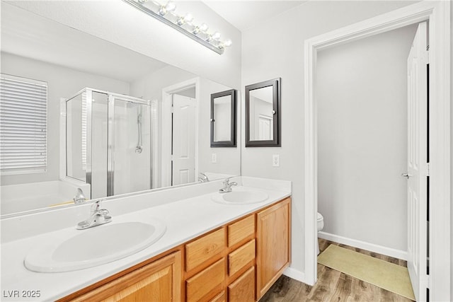 981 Leadville Meadows Dr, Henderson, NV 89052 - full bathroom featuring a stall shower, double vanity, and wood finished floors