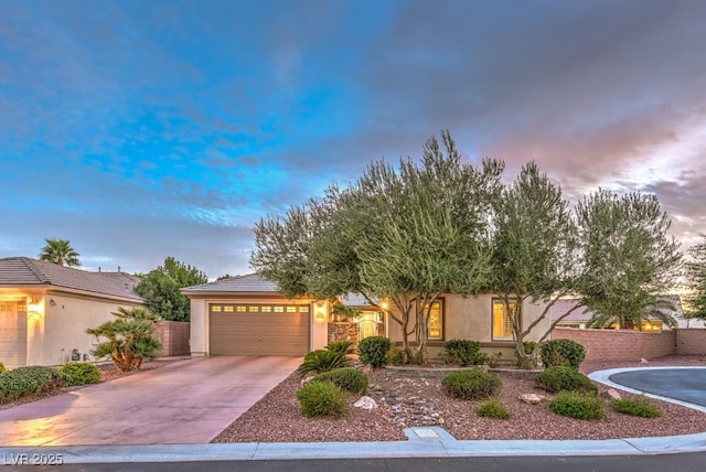 8633 Kennedy Heights Ct, Las Vegas, NV 89131 - view of property hidden behind natural elements featuring a garage, stucco siding, and driveway