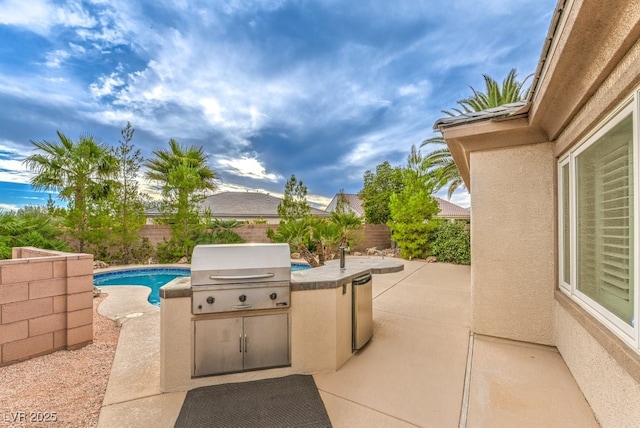 8633 Kennedy Heights Ct, Las Vegas, NV 89131 - fenced backyard featuring exterior kitchen and a patio area