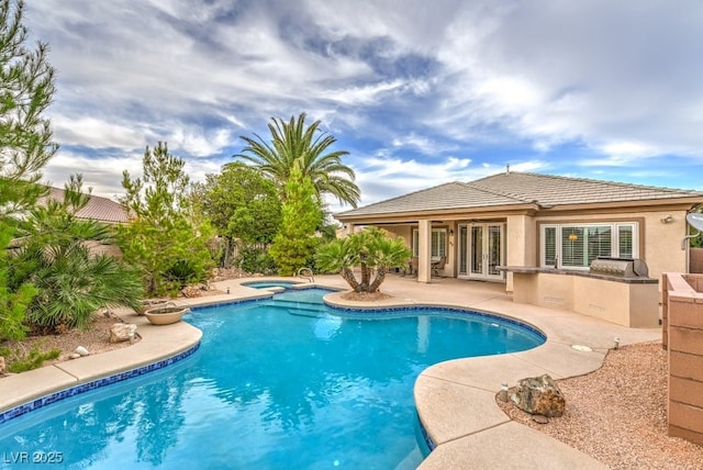 8633 Kennedy Heights Ct, Las Vegas, NV 89131 - swimming pool featuring french doors, an in-ground hot tub, a patio, and an outdoor kitchen