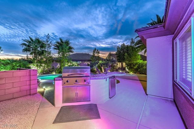 8633 Kennedy Heights Ct, Las Vegas, NV 89131 - patio terrace at dusk featuring exterior kitchen and a patio area