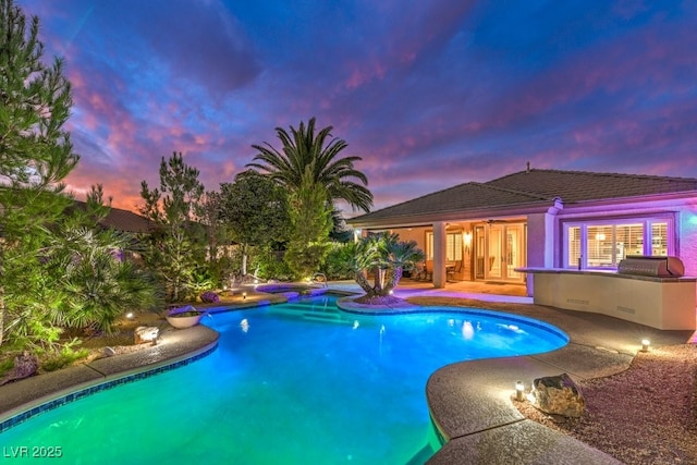 8633 Kennedy Heights Ct, Las Vegas, NV 89131 - pool at dusk featuring an outdoor pool, a patio, and grilling area