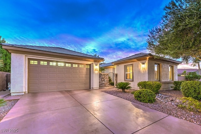 8633 Kennedy Heights Ct, Las Vegas, NV 89131 - view of front of house with stucco siding, driveway, and an attached garage