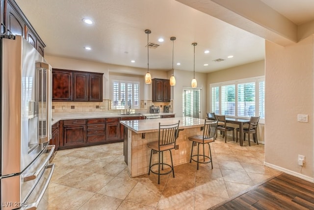 8633 Kennedy Heights Ct, Las Vegas, NV 89131 - kitchen with high quality fridge, light countertops, a kitchen breakfast bar, a center island, and recessed lighting