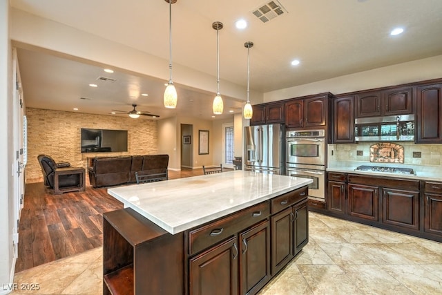 8633 Kennedy Heights Ct, Las Vegas, NV 89131 - kitchen with appliances with stainless steel finishes, light countertops, ceiling fan, pendant lighting, and recessed lighting