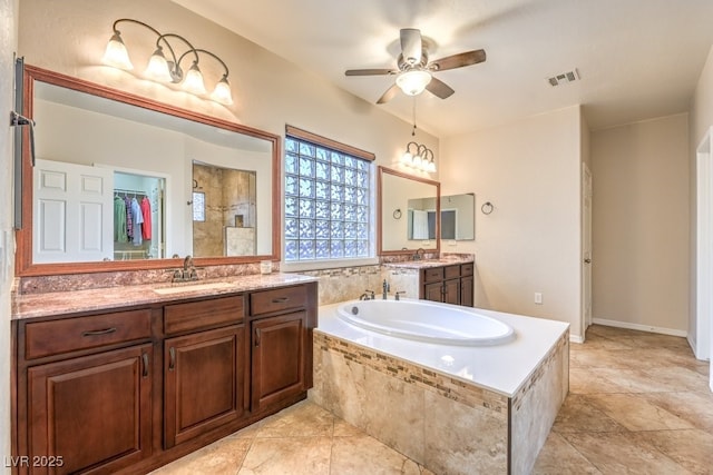 8633 Kennedy Heights Ct, Las Vegas, NV 89131 - full bathroom featuring a bath, two vanities, ceiling fan, tiled shower, and a spacious closet