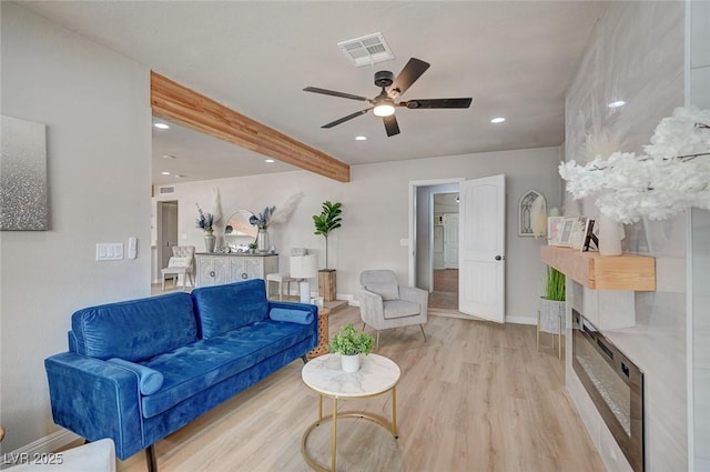 700 Cactus Ln, Las Vegas, NV 89107 - living area with light wood-style flooring, beamed ceiling, ceiling fan, recessed lighting, and a tile fireplace