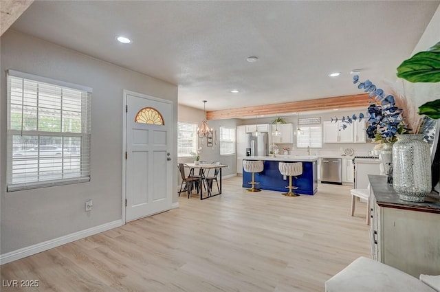 700 Cactus Ln, Las Vegas, NV 89107 - foyer with light wood-style flooring, recessed lighting, and a chandelier