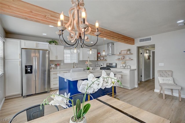 700 Cactus Ln, Las Vegas, NV 89107 - kitchen featuring stainless steel appliances, open shelves, a chandelier, light countertops, and white cabinets