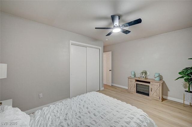 700 Cactus Ln, Las Vegas, NV 89107 - bedroom with light wood finished floors, a ceiling fan, and a closet