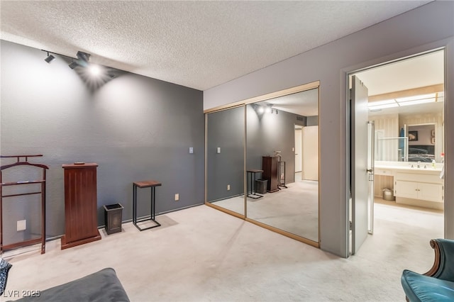 2857 San Lago Ct, Las Vegas, NV 89121 - unfurnished bedroom featuring carpet, a textured ceiling, and a closet