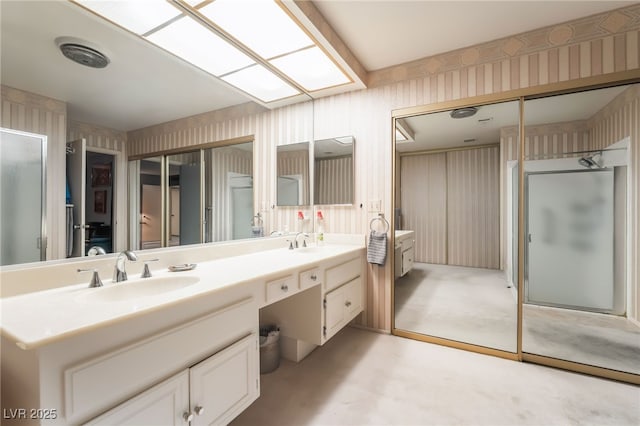 2857 San Lago Ct, Las Vegas, NV 89121 - full bathroom with wallpapered walls, double vanity, and a stall shower