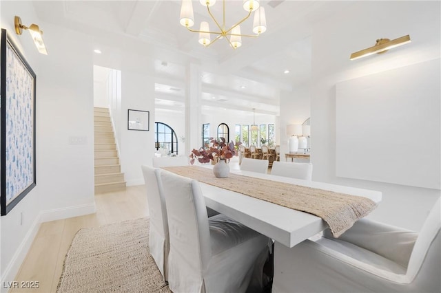 1990 Country Cove Ct, Las Vegas, NV 89135 - dining area featuring a chandelier, stairway, light wood-style floors, beam ceiling, and coffered ceiling