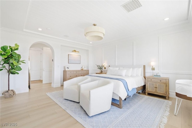 1990 Country Cove Ct, Las Vegas, NV 89135 - bedroom featuring arched walkways, light wood-style floors, ornamental molding, recessed lighting, and a decorative wall