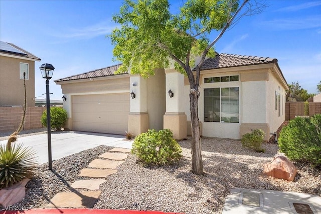10613 Tiffanieville Ct, Las Vegas, NV 89129 - mediterranean / spanish house featuring stucco siding, a tiled roof, concrete driveway, and a garage