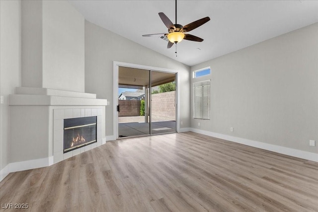 10613 Tiffanieville Ct, Las Vegas, NV 89129 - unfurnished living room with lofted ceiling, wood finished floors, ceiling fan, and a tiled fireplace