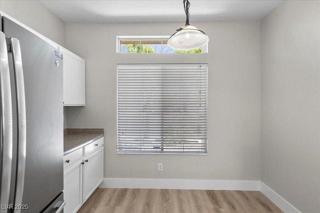 10613 Tiffanieville Ct, Las Vegas, NV 89129 - unfurnished dining area featuring light wood-style floors and baseboards