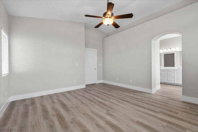 10613 Tiffanieville Ct, Las Vegas, NV 89129 - spare room with a ceiling fan, wood finished floors, arched walkways, and vaulted ceiling