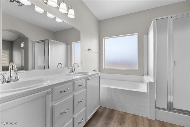 10613 Tiffanieville Ct, Las Vegas, NV 89129 - bathroom featuring double vanity, wood finished floors, a bath, and a shower stall