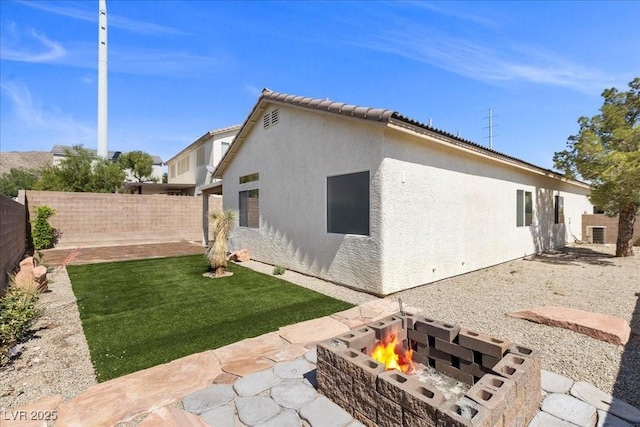 10613 Tiffanieville Ct, Las Vegas, NV 89129 - rear view of house featuring a fire pit, a fenced backyard, stucco siding, and a patio