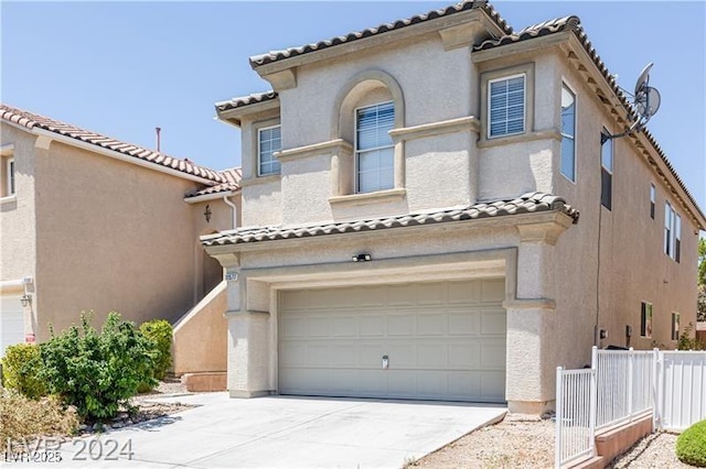11577 Vesuvio Ct, Las Vegas, NV 89183 - mediterranean / spanish home with an attached garage, a tile roof, stucco siding, and driveway