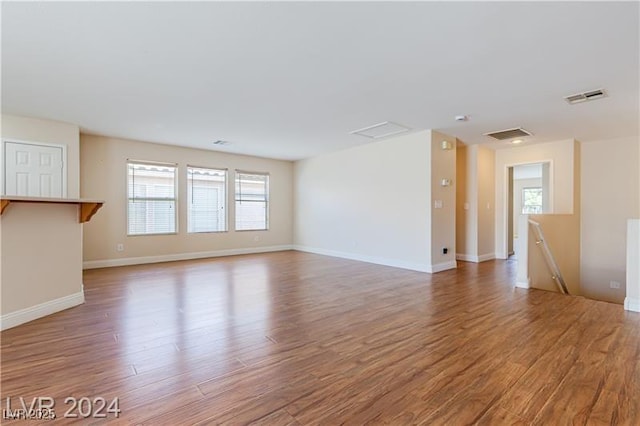 11577 Vesuvio Ct, Las Vegas, NV 89183 - unfurnished living room featuring light wood-style floors and baseboards