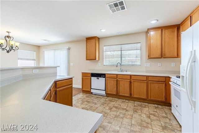 11577 Vesuvio Ct, Las Vegas, NV 89183 - kitchen featuring white appliances, light countertops, brown cabinets, a chandelier, and recessed lighting