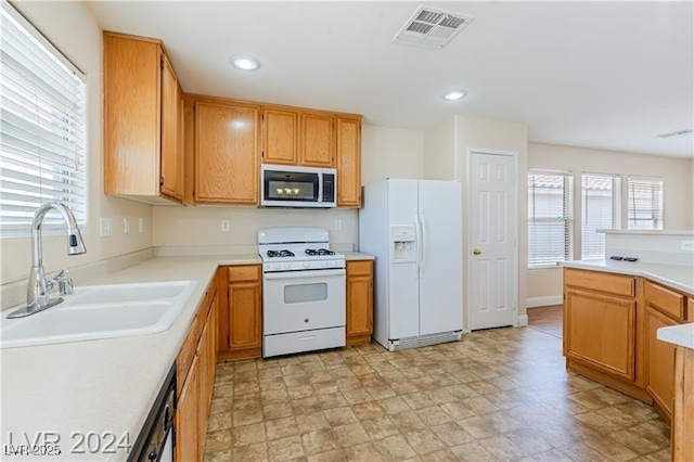 11577 Vesuvio Ct, Las Vegas, NV 89183 - kitchen featuring white appliances, light countertops, and recessed lighting