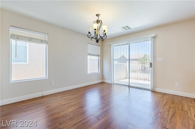 11577 Vesuvio Ct, Las Vegas, NV 89183 - unfurnished room featuring a chandelier and wood finished floors