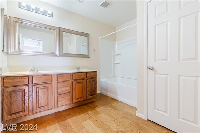 11577 Vesuvio Ct, Las Vegas, NV 89183 - full bath featuring double vanity, wood finished floors, and  shower combination