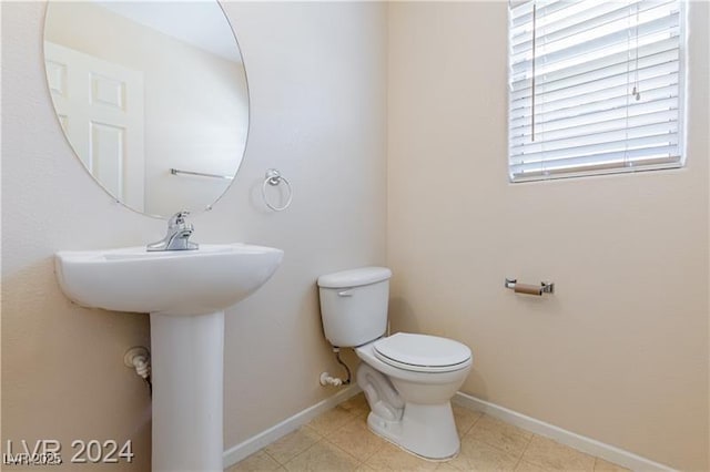 11577 Vesuvio Ct, Las Vegas, NV 89183 - half bath featuring toilet and baseboards