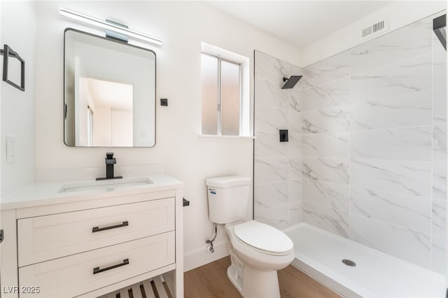 3915 Delling Ct, Las Vegas, NV 89104 - bathroom with vanity, tiled shower, and wood finished floors