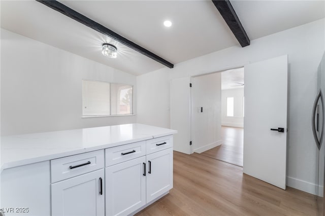 3915 Delling Ct, Las Vegas, NV 89104 - kitchen with white cabinets, light wood finished floors, light stone countertops, and a ceiling fan